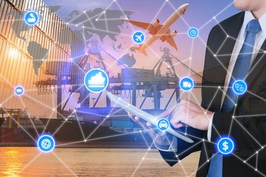 Businessman using digital tablet with logistics and transportation icons overlay.