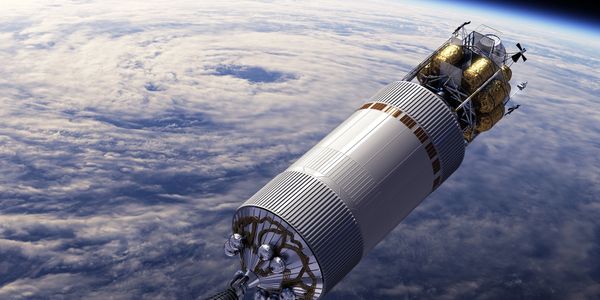 A spacecraft orbiting Earth above the clouds.