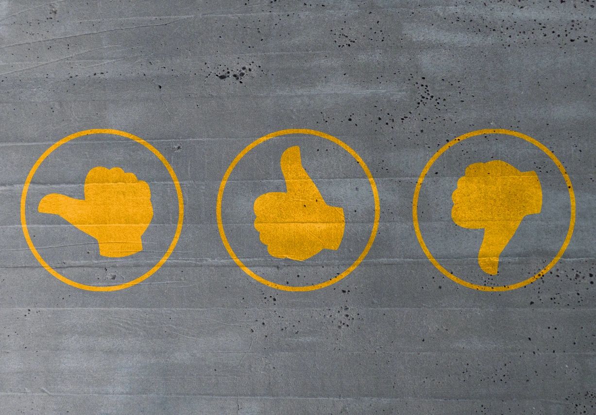 Three circled orange images; of a thumb sideways, a thumbs up, and a thumbs down.