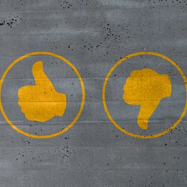 Stock image of thumbs up and down.