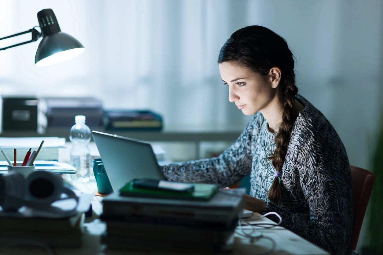 Young girl studying English at her computer