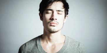 Portrait of a young man with eyes closed.