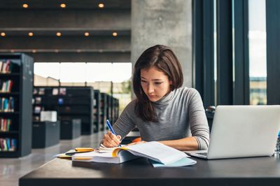 Girl studying in a library.