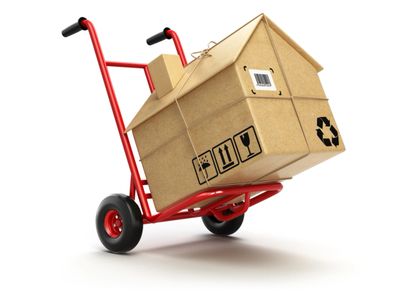 House-shaped moving box on a dolly