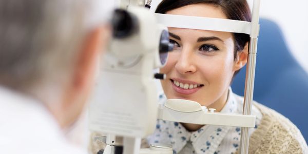 Board Certified Optometrist using a slit lamp bio-microscope to examine a patient's external eye