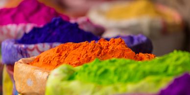Colorful powdered pigments in bags, used for festivals like Holi.
