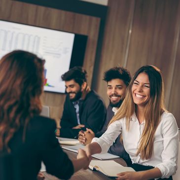 Happy clients in boardroom discussing how media training can meet their business needs