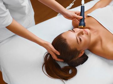 A woman receiving advanced skincare treatment

