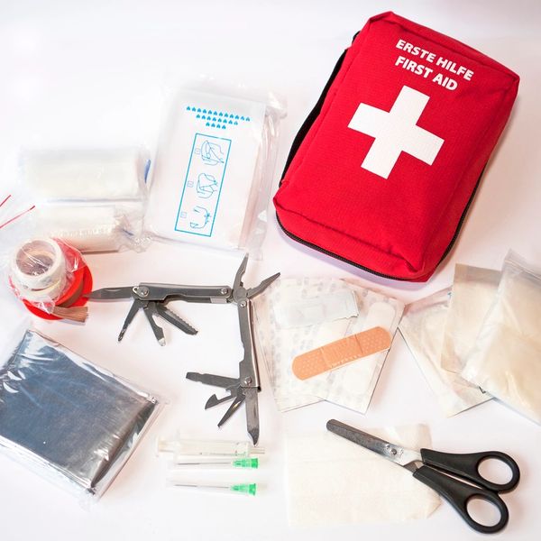 First kit and possible contents: Emergency blanket, scissors, plasters and bandages.