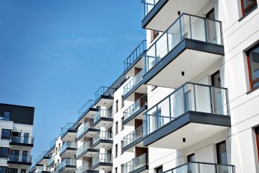 Modern apartment balconies with glass railings.