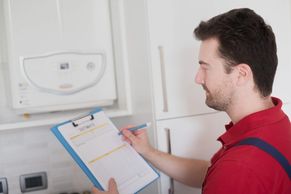 Man checking a central heating boiler