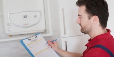 A man checking a central heating boiler