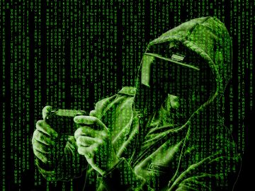 Hacker in hoodie with green code.