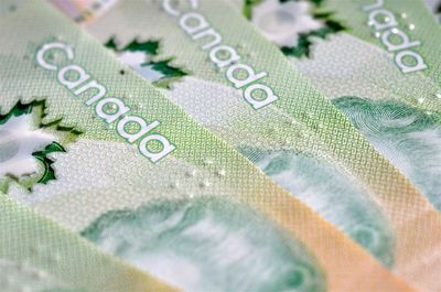 Close-up of Canadian banknotes showing detailed security features.