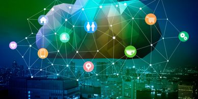 Digital cloud network with interconnected icons over a cityscape at night.