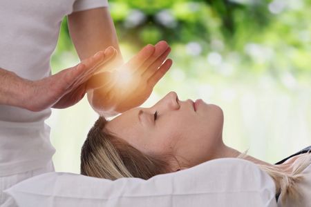 Reiki practioner sending energy to the client