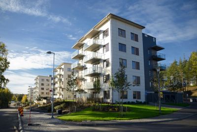 Modern apartment buildings with balconies on a sunny day.