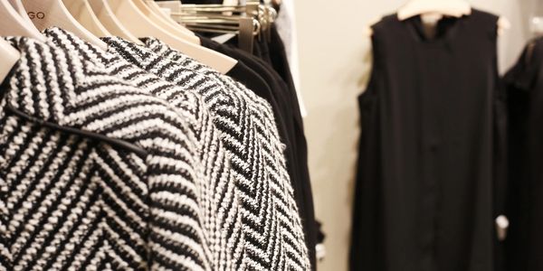 Winter clothing and dresses on hangers in closet