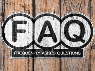 FAQ acronym on wooden background.