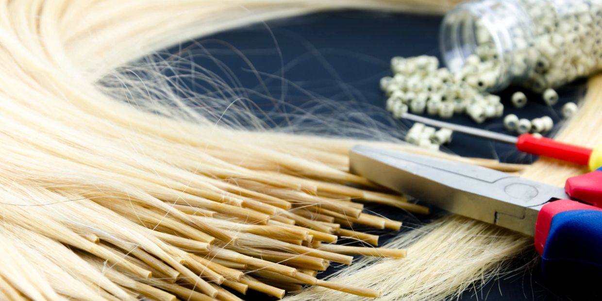 Tools and blonde hair strands for hair extension.