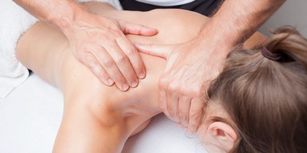 Neck and shoulder massage on client