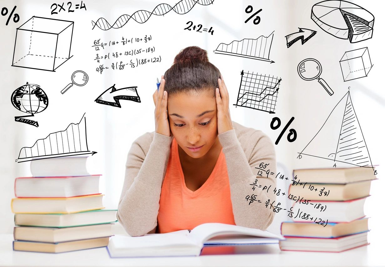 A young lady studies along-side all her books.