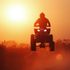 ATV riders crossing rocky terrain