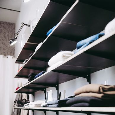 Shelves with neatly folded clothes.