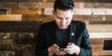 a man looking at his cell phone