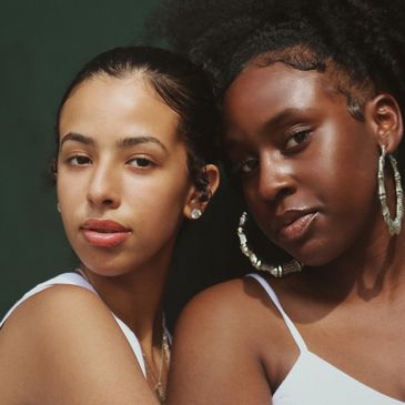 Close-up of two women with glowing skin and natural beauty.