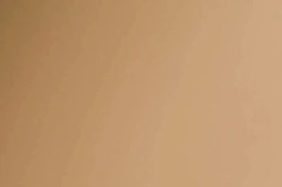 A smooth gradient of warm beige tones.