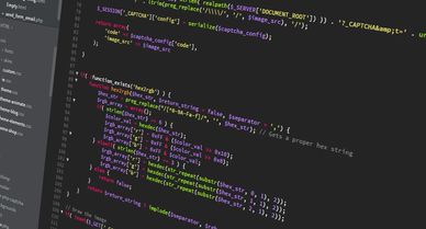 Close-up of colorful JavaScript code on a dark background.