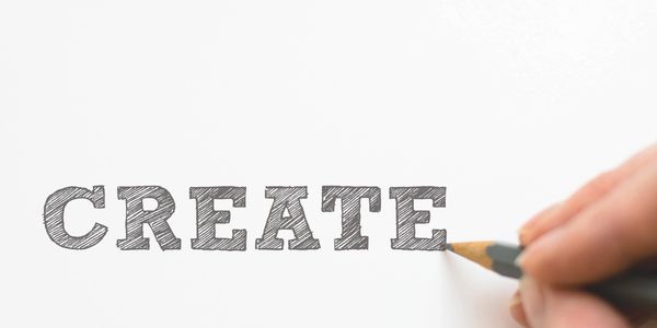 Designer using pencil making graphic of create text.