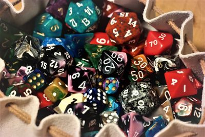 A collection of various colorful polyhedral dice in a dice tray.