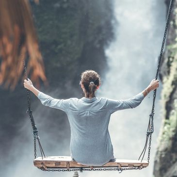 Woman sitting on swing feeling great after receiving IV Vitamin Therapy