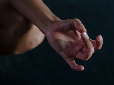 Hand making a mudra gesture.