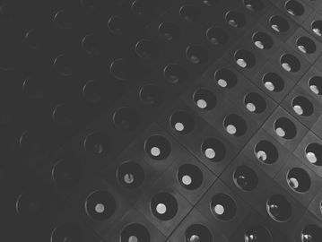 Black and white grid of circular reflections creating a geometric pattern.