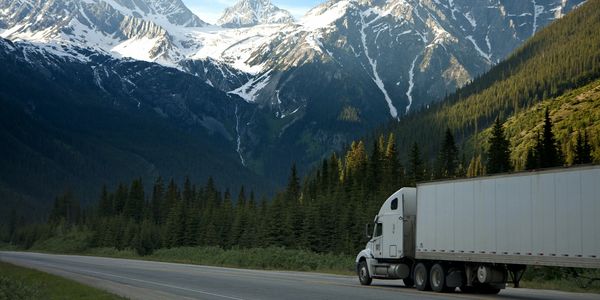 Truck driving on Highway with Beautiful Mountains in the Background