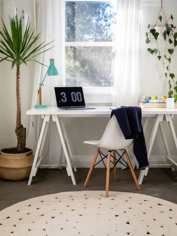 Minimalist home office setup with white desk and chair.