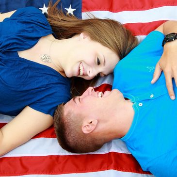 Couple lying on a US flag.