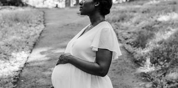 Mom holding pregnant stomach- Geaux Dat Doula