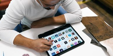 A picture of a man working on his smart tablet