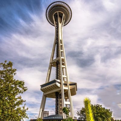 The iconic Space Needle tower in Seattle under a dramatic sky.