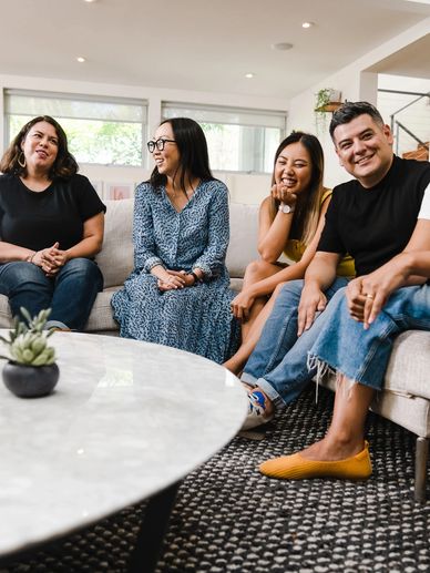 Group of people sitting together - chatting and laughing