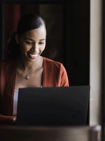 Woman looking at a computer with a smile