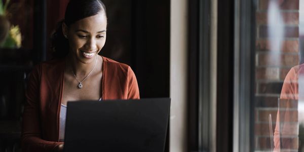 Lady enjoying working on her laptop