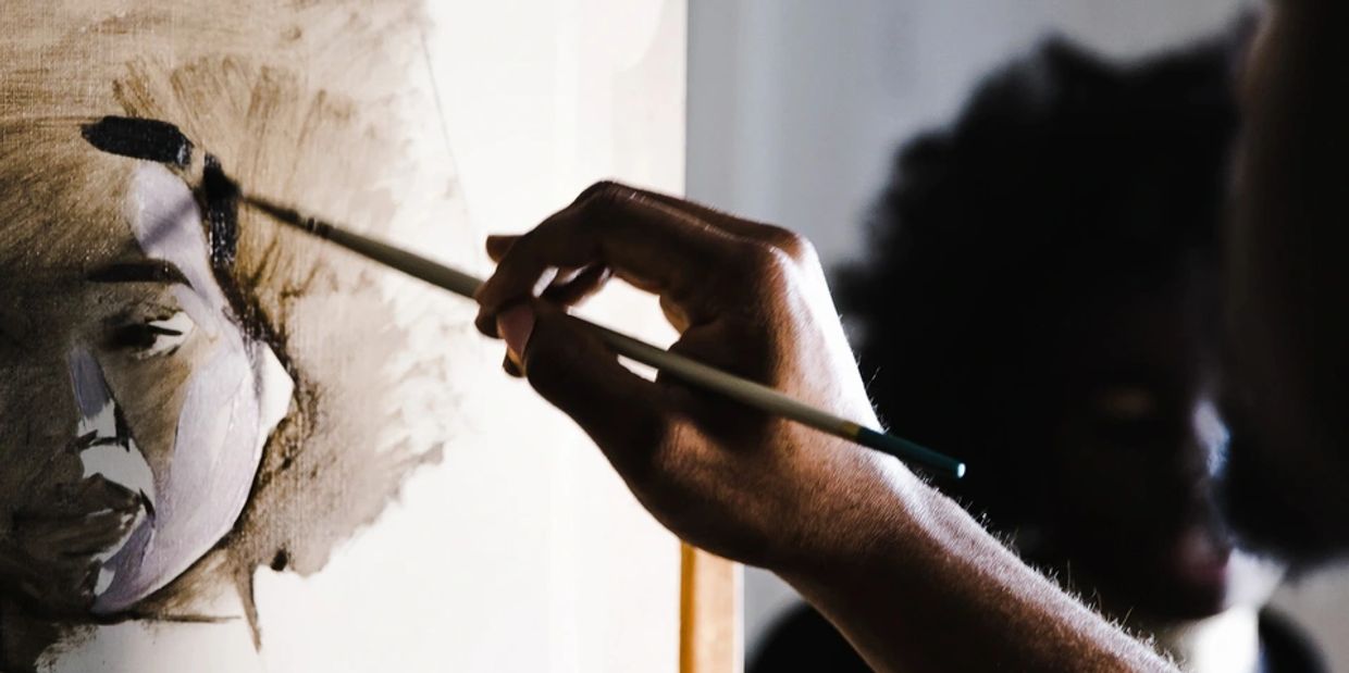 A man painting on the board 
