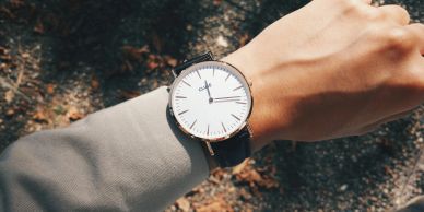 Close-up of a wristwatch on a person's wrist in natural light.