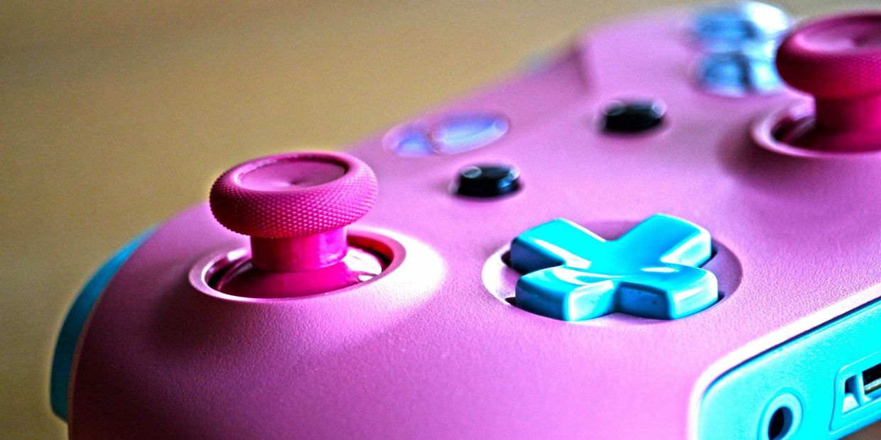Pink and turquoise game controller. 