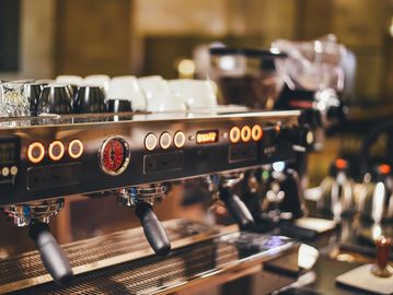 Close-up of a professional espresso machine in a cozy café.